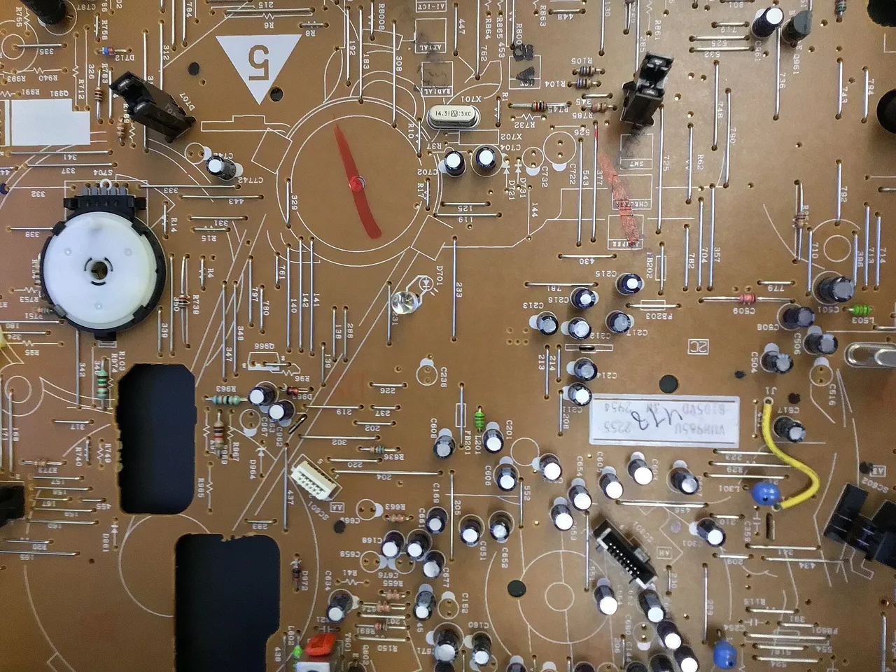 A close view of a green circuit board with electronic components